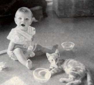 Carla as a baby with a kitten